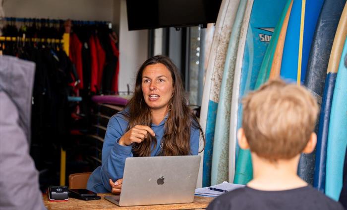 Image of staff member talking to customers at reception